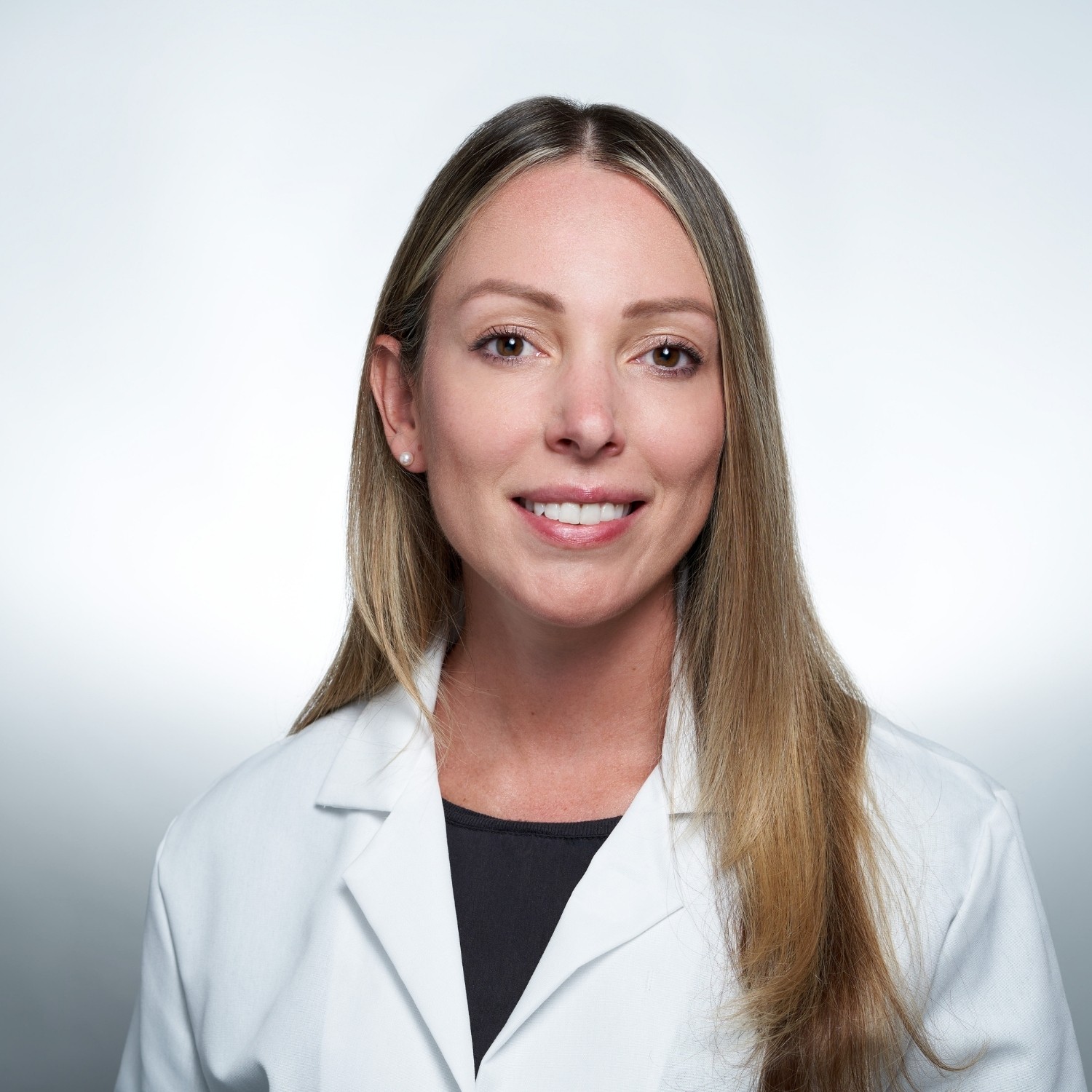 female doctor headshot in white lab coat