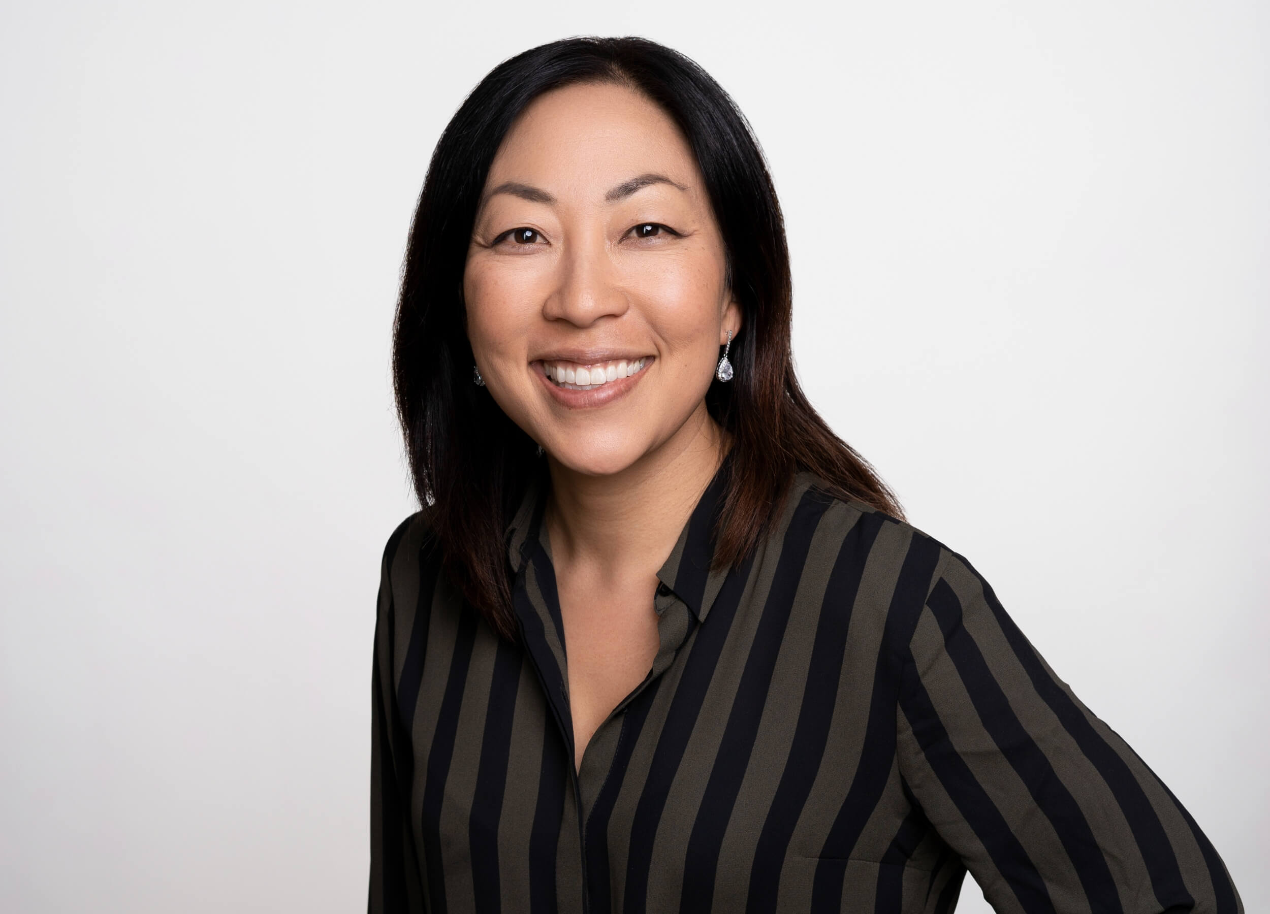 executive headshots of women in striped top on white