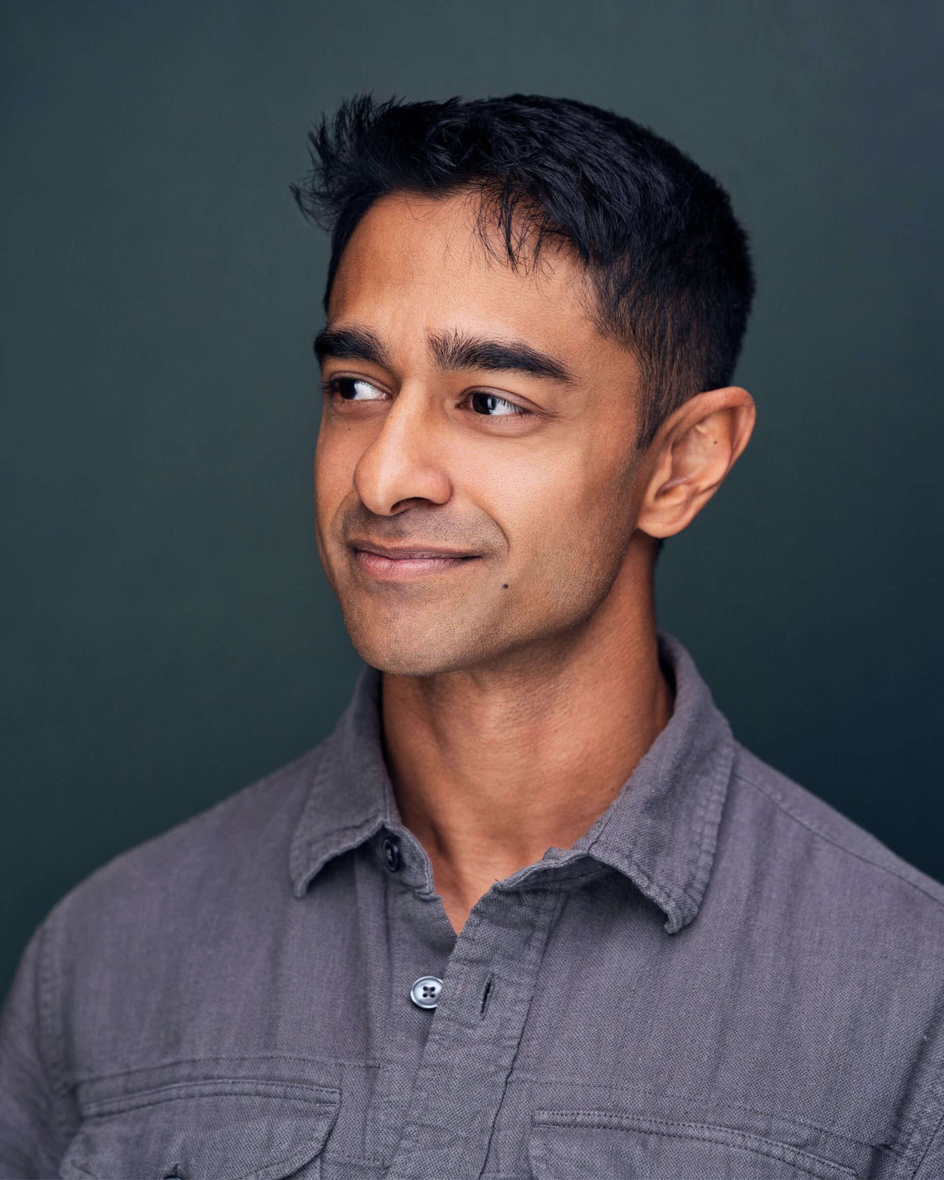 casual business headshot on green background